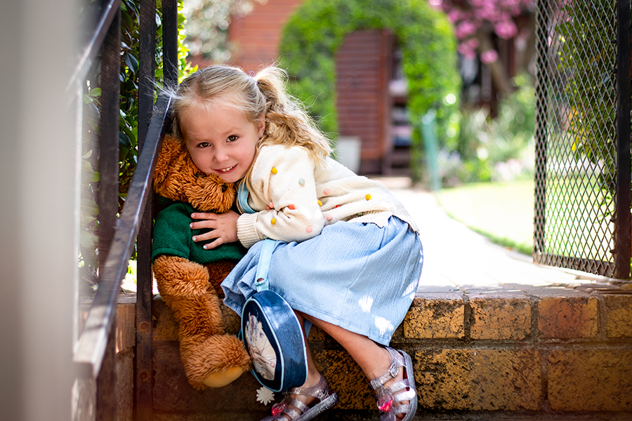 girl hugging teddy
